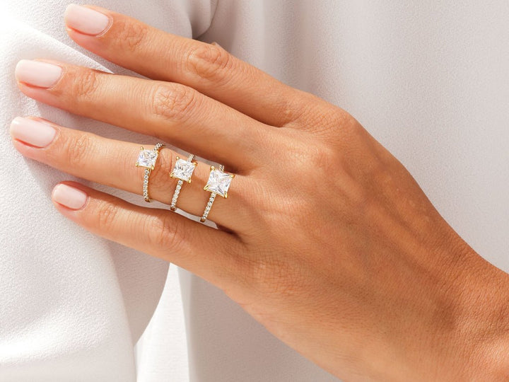 Close-up of princess cut center diamond in pave engagement ring