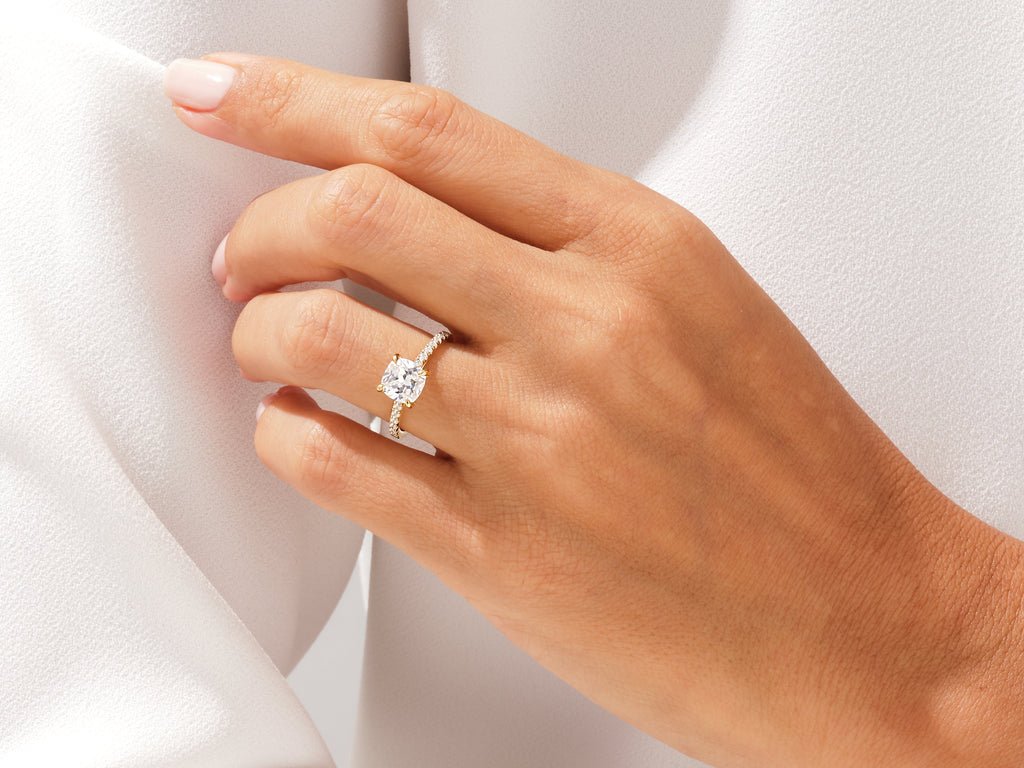 Cushion cut pave engagement ring shown in real-life wear