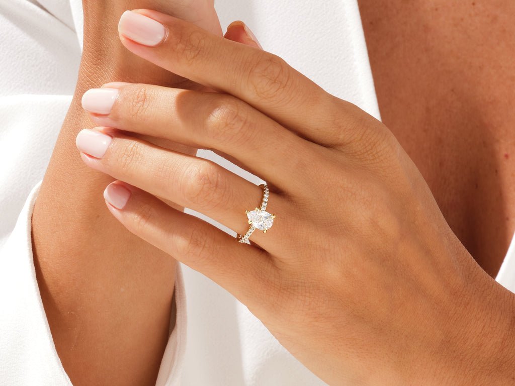 Profile view of pear cut pave engagement ring band