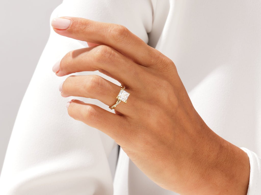 Close-up of princess cut center diamond in pave engagement ring
