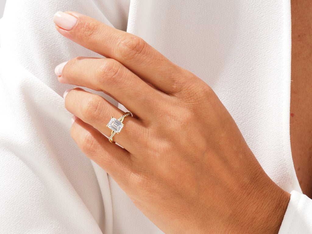 Emerald solitaire engagement ring shown on hand for true-to-life sizing