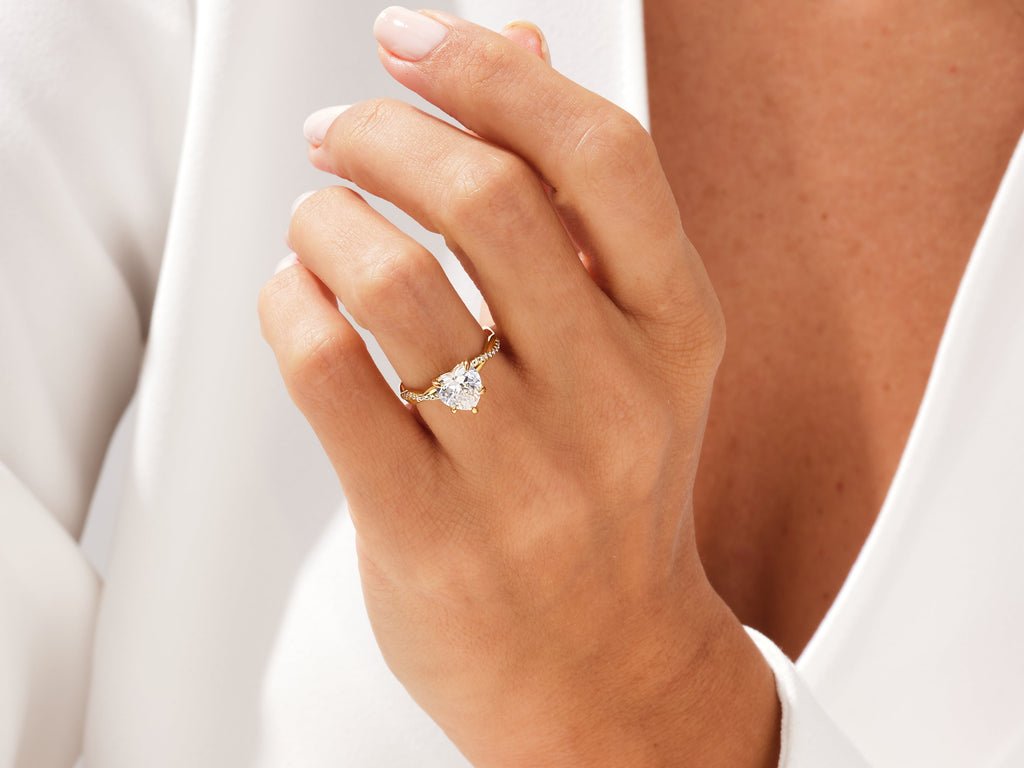 Lifestyle shot of heart solitaire diamond ring on hand