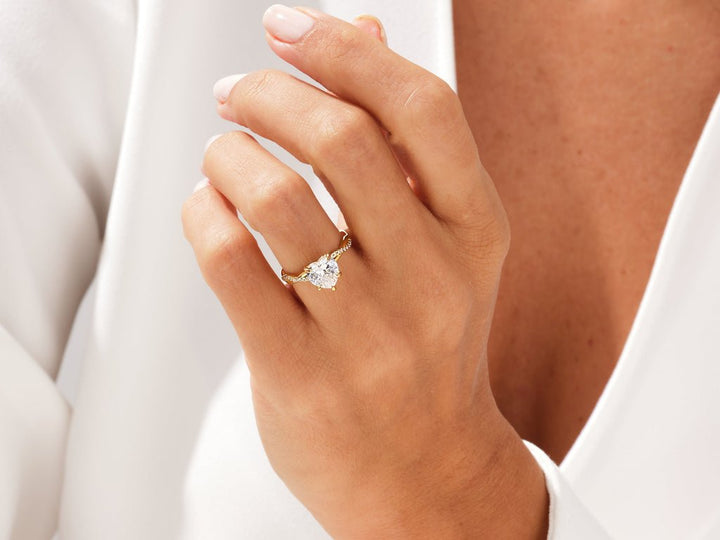 Lifestyle shot of heart solitaire diamond ring on hand