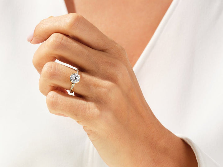 Round cut solitaire engagement ring shown in real-life wear