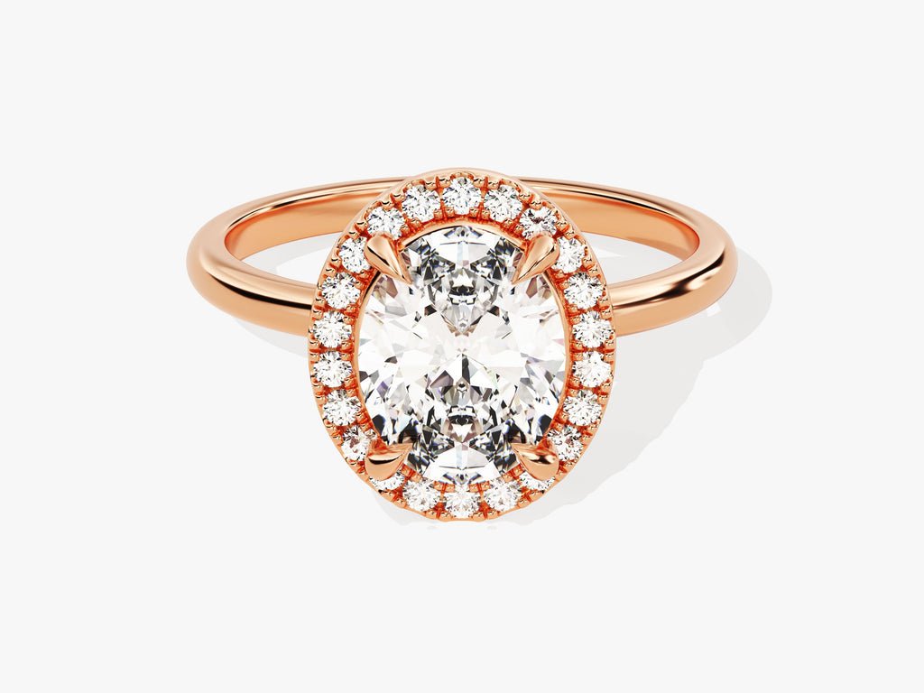 Close-up of oval cut center diamond in halo engagement ring