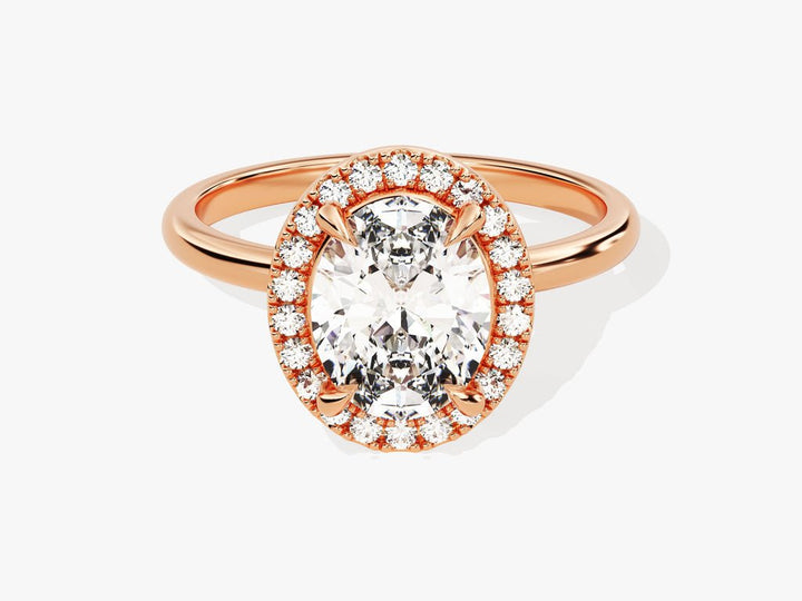 Close-up of oval cut center diamond in halo engagement ring