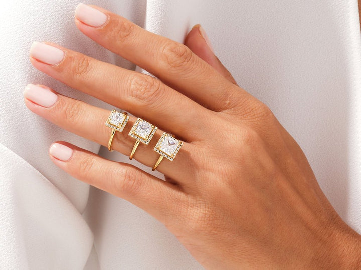 Princess halo engagement ring offered in gold and platinum