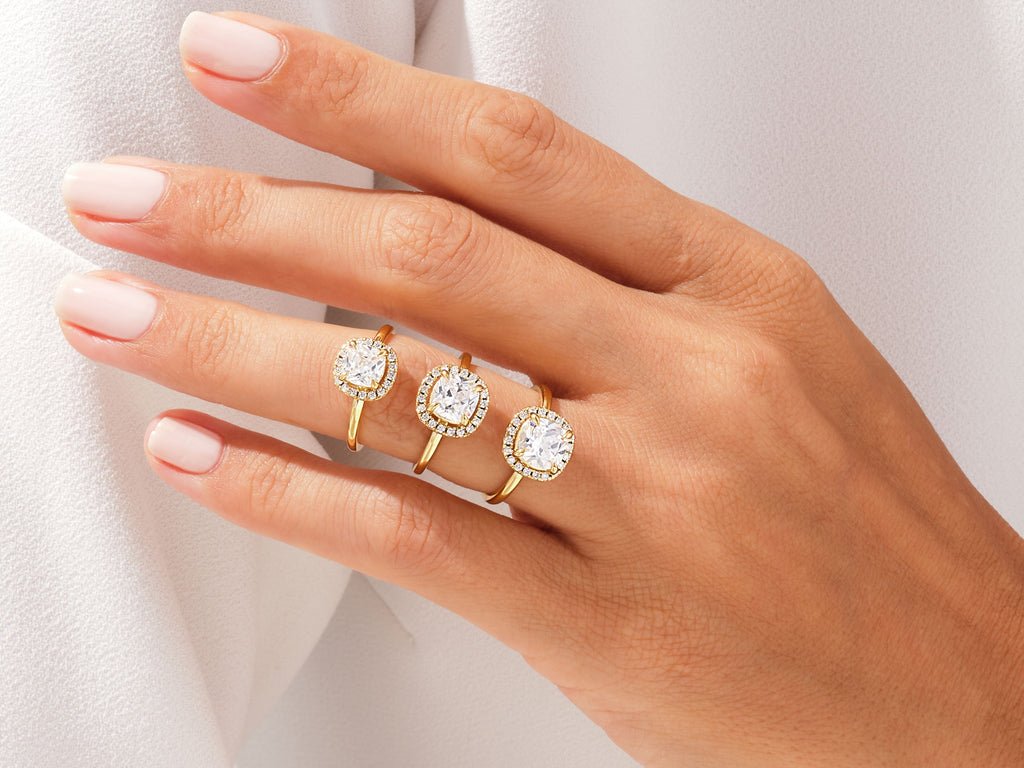 Lifestyle shot of cushion halo diamond ring on hand