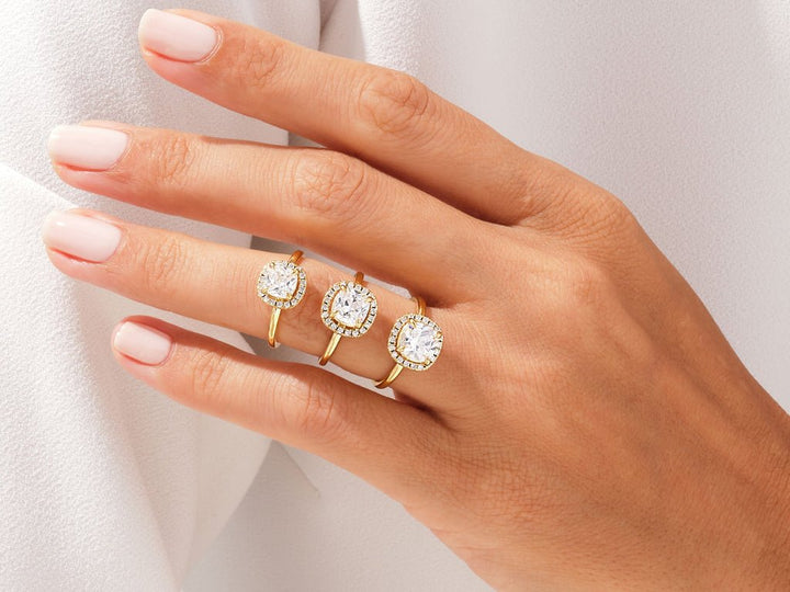 Lifestyle shot of cushion halo diamond ring on hand