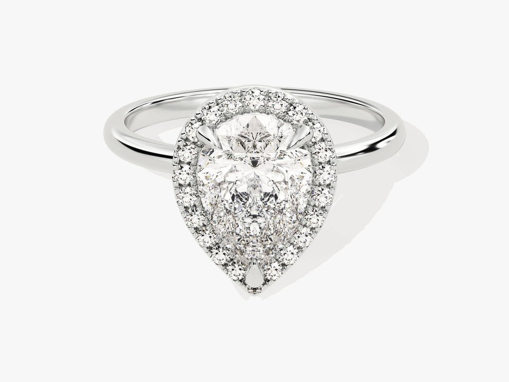 Pear halo engagement ring photographed in natural light