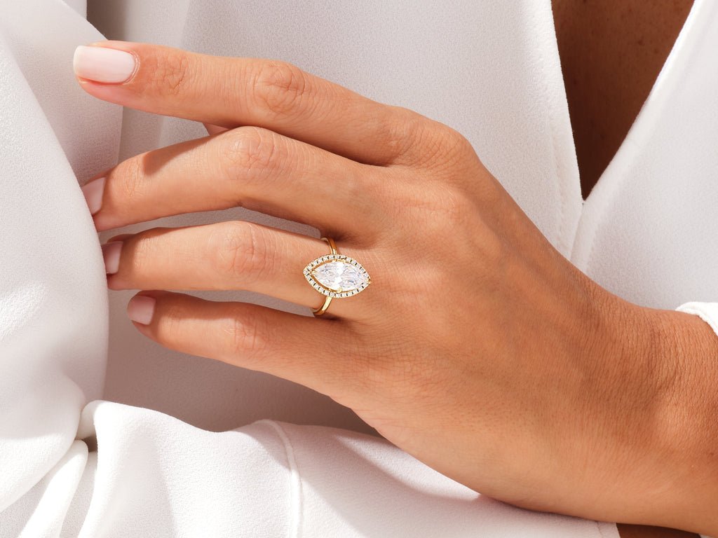 Angled view of marquise cut diamond in halo setting