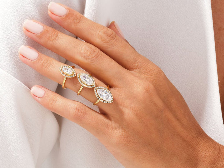 Marquise halo engagement ring finished in polished solid gold