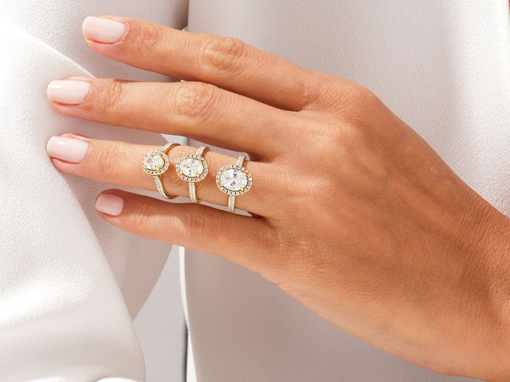 Certified oval cut diamond featured in pave engagement ring