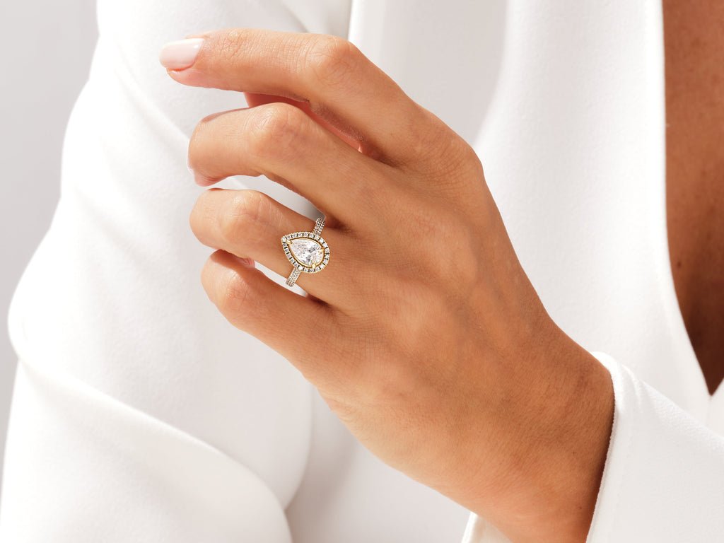 Pear pave engagement ring shown on hand for true-to-life sizing