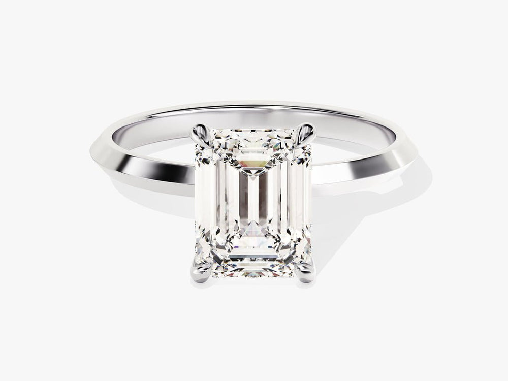 Emerald solitaire engagement ring viewed from the side