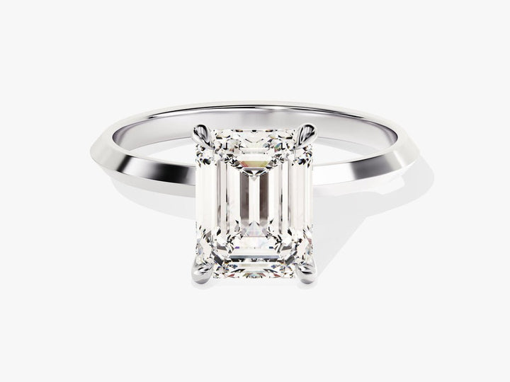 Emerald solitaire engagement ring viewed from the side
