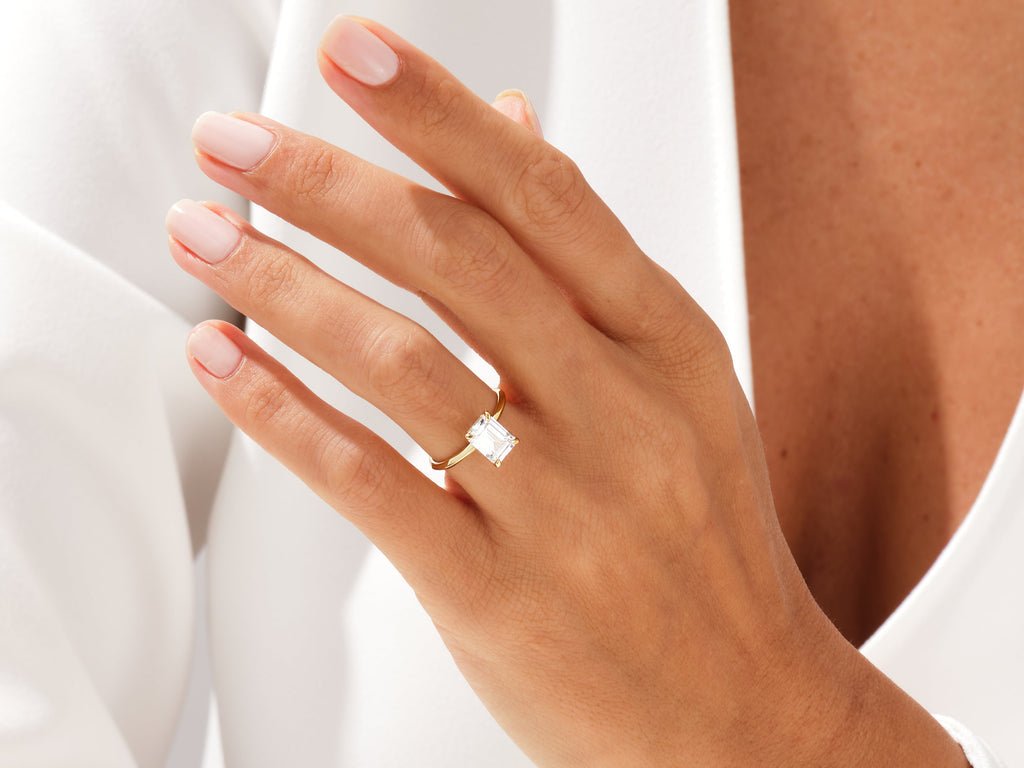 Emerald cut solitaire engagement ring with IGI certified center diamond