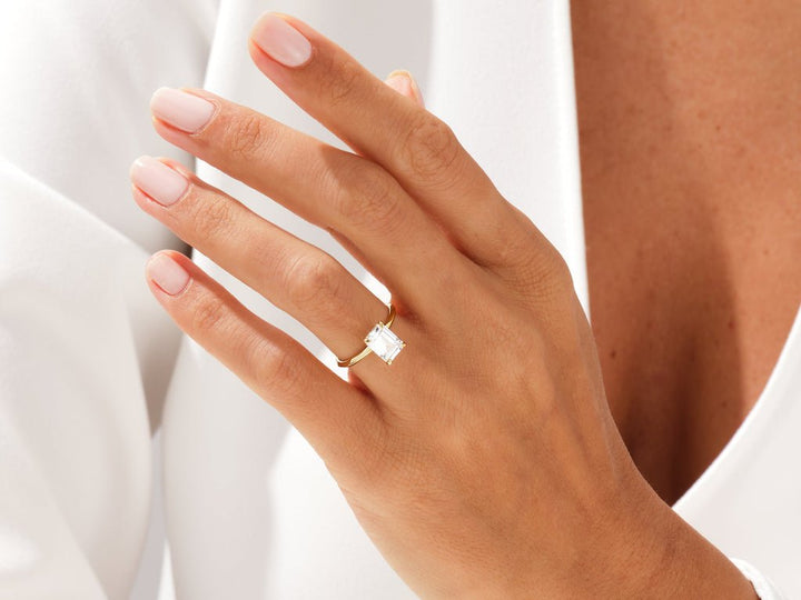 Emerald cut solitaire engagement ring with IGI certified center diamond