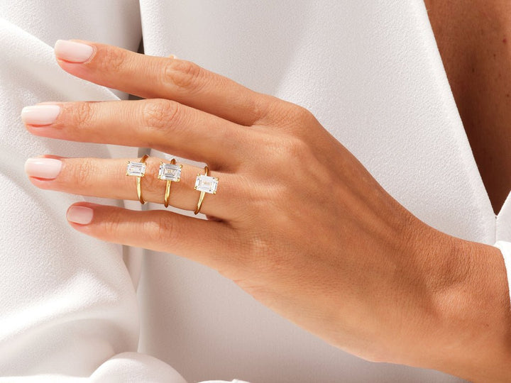Emerald cut diamond ring worn on hand