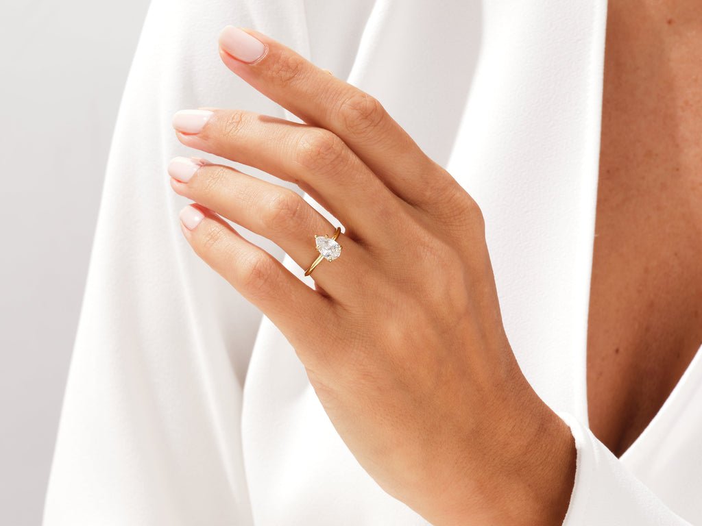 Pear solitaire engagement ring photographed in natural light