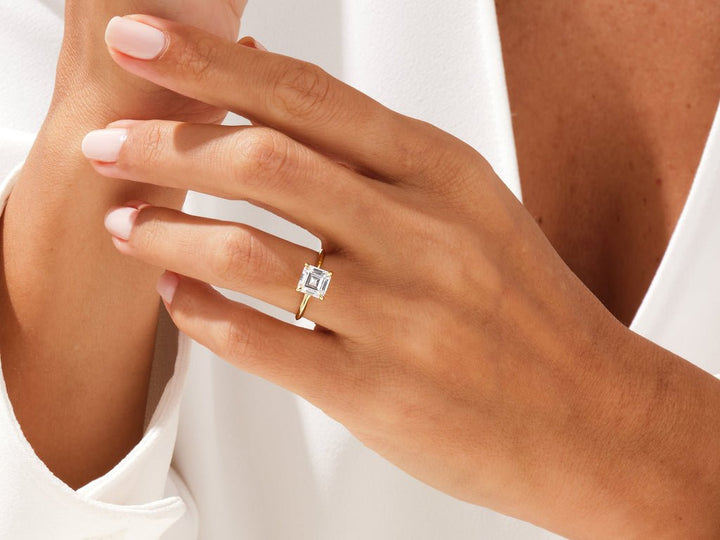 Asscher solitaire diamond ring displayed on jewelry stand