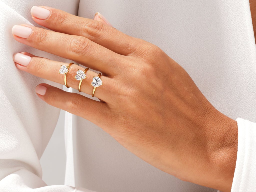 Lifestyle shot of heart solitaire diamond ring on hand