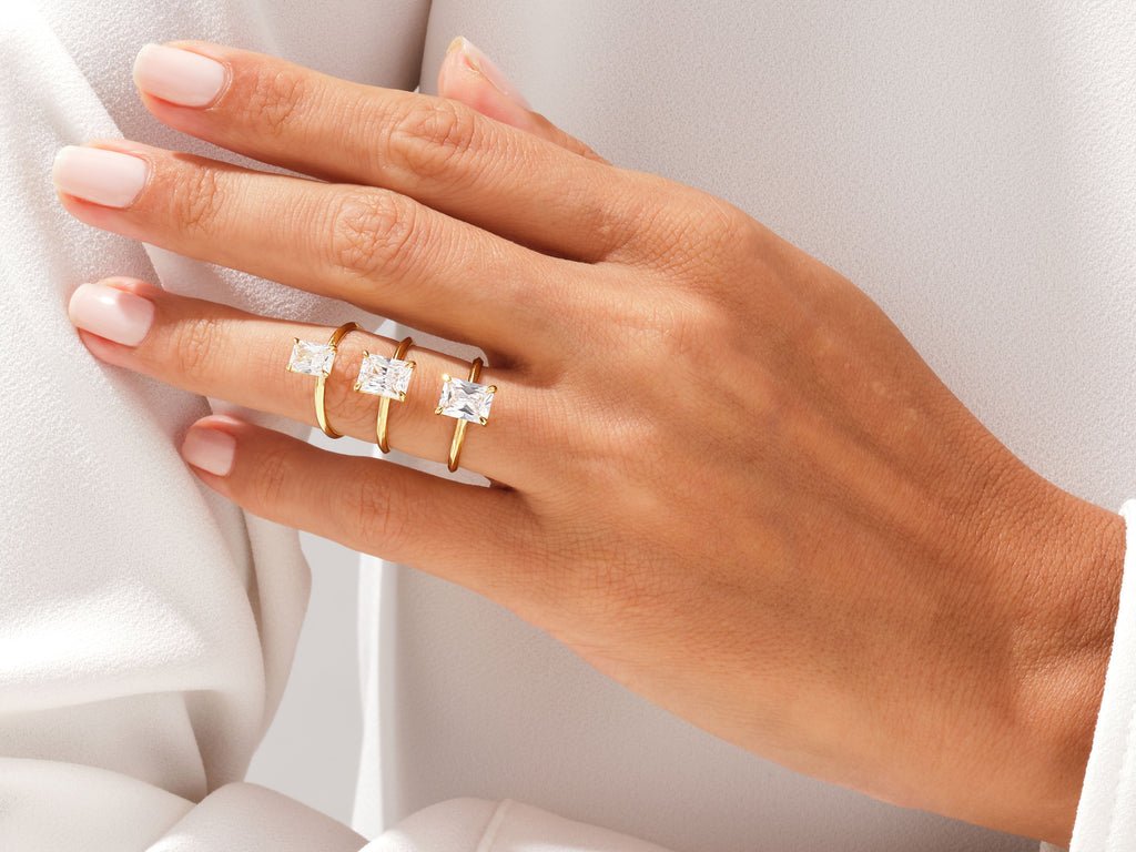 Radiant solitaire engagement ring photographed in natural light