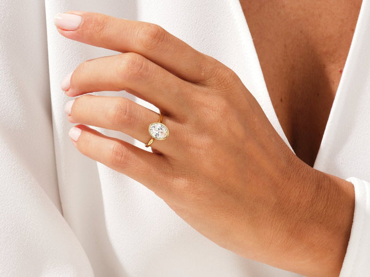 Classic oval bezel engagement ring crafted for everyday wear