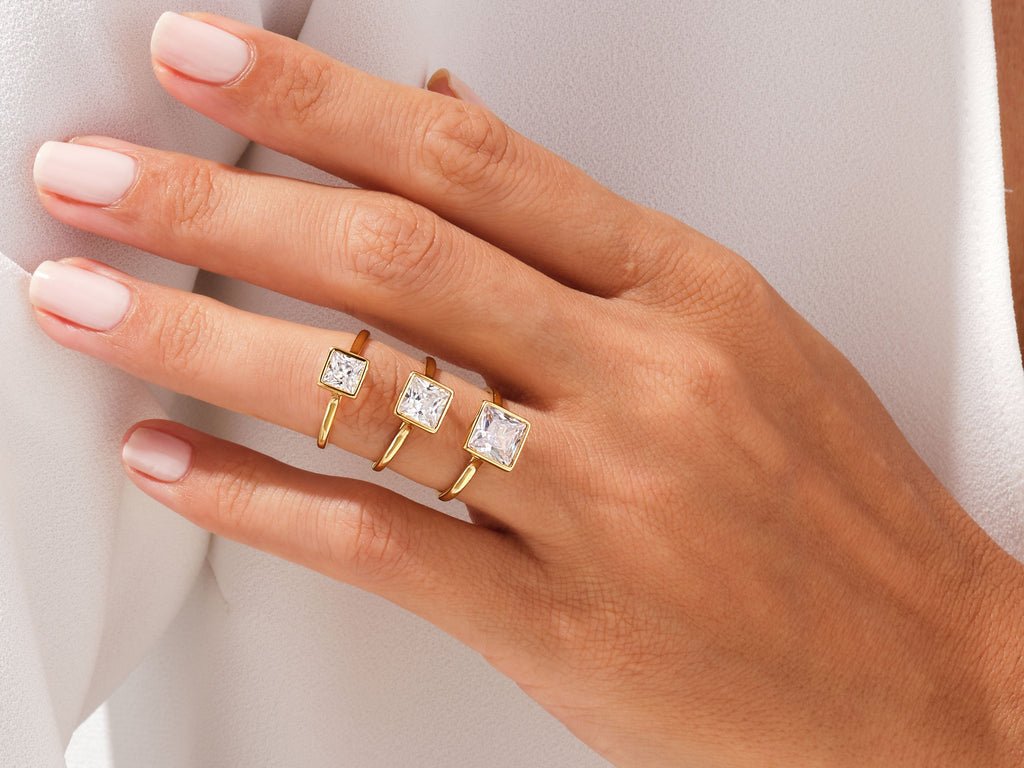 Macro shot of princess cut diamond facets in bezel ring setting