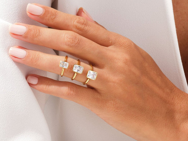 Certified radiant cut diamond featured in bezel engagement ring