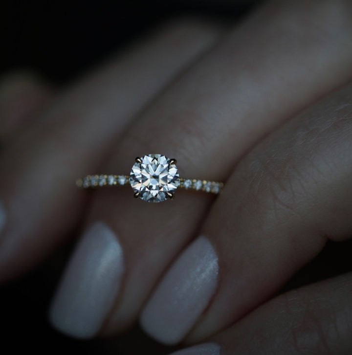 Profile view of round cut solitaire engagement ring band