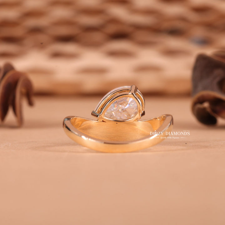Profile view of pear cut east west engagement ring band