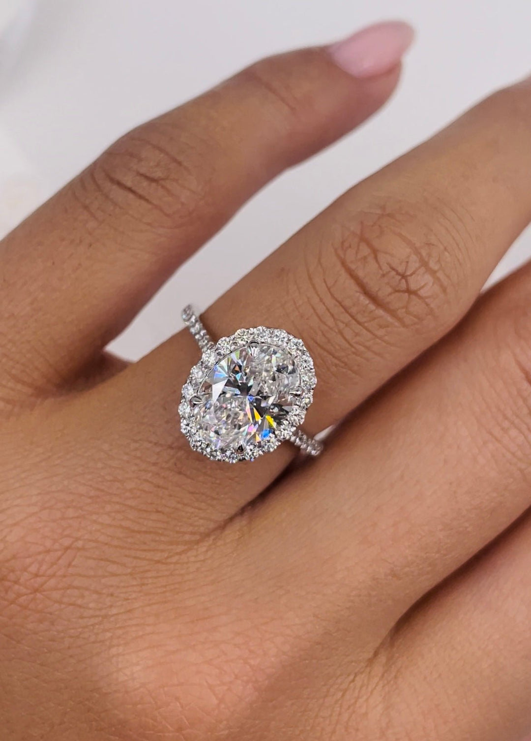 Oval cut engagement ring shown with authenticity certificate