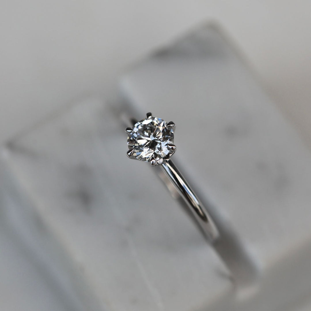 Round solitaire diamond ring presented in signature gift packaging