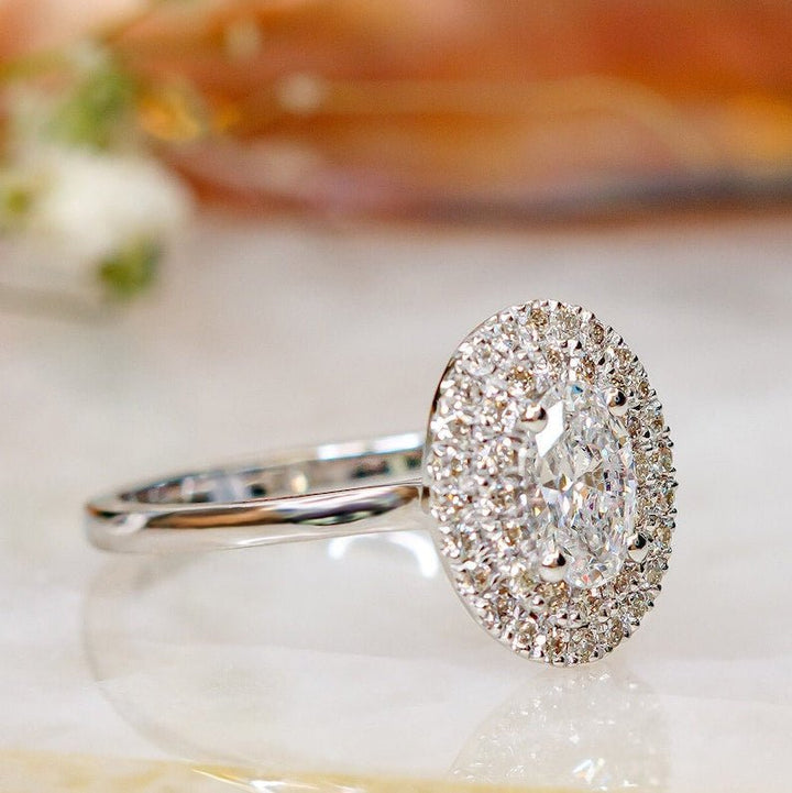 Detailed close-up of oval halo diamond engagement ring