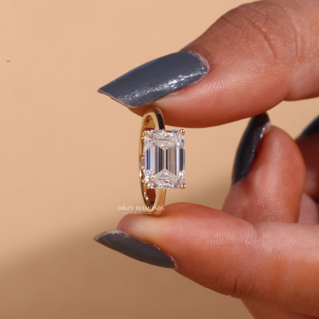 Close-up of emerald cut center diamond in east west engagement ring
