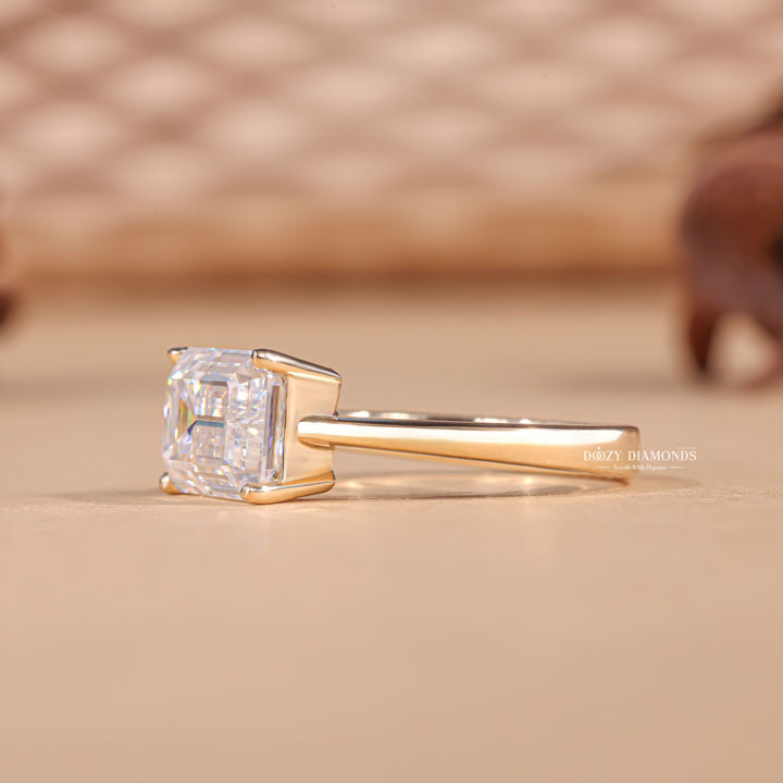 Side angle of emerald east west diamond engagement ring