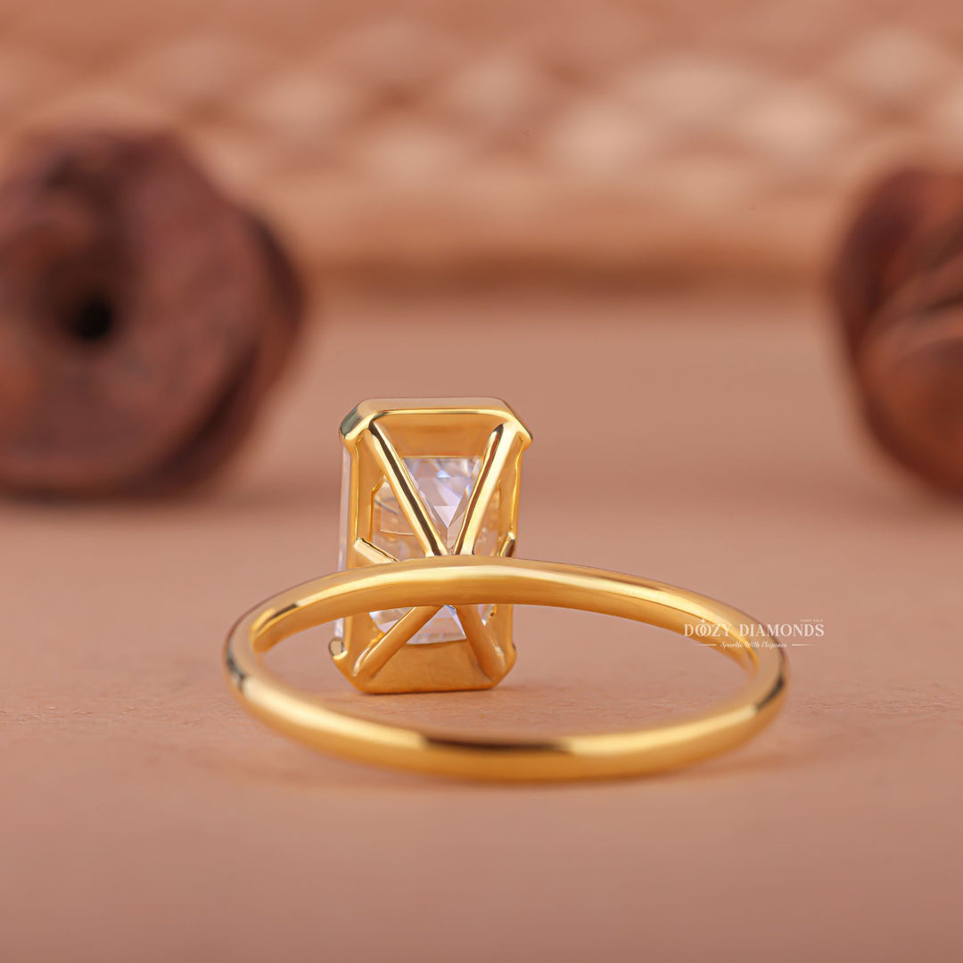Unboxing view of emerald cut bezel diamond engagement ring