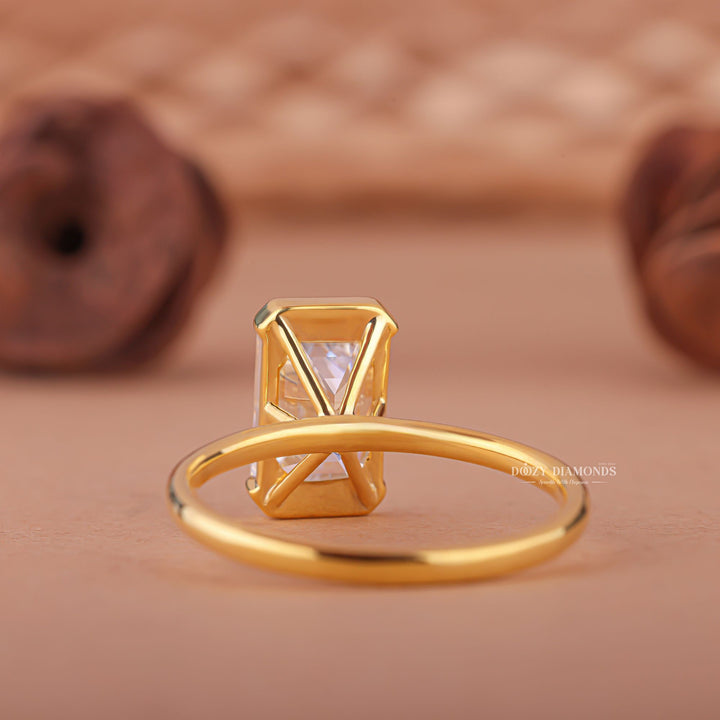 Unboxing view of emerald cut bezel diamond engagement ring