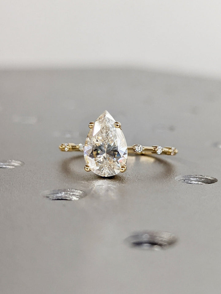 Pear pave engagement ring viewed from the side
