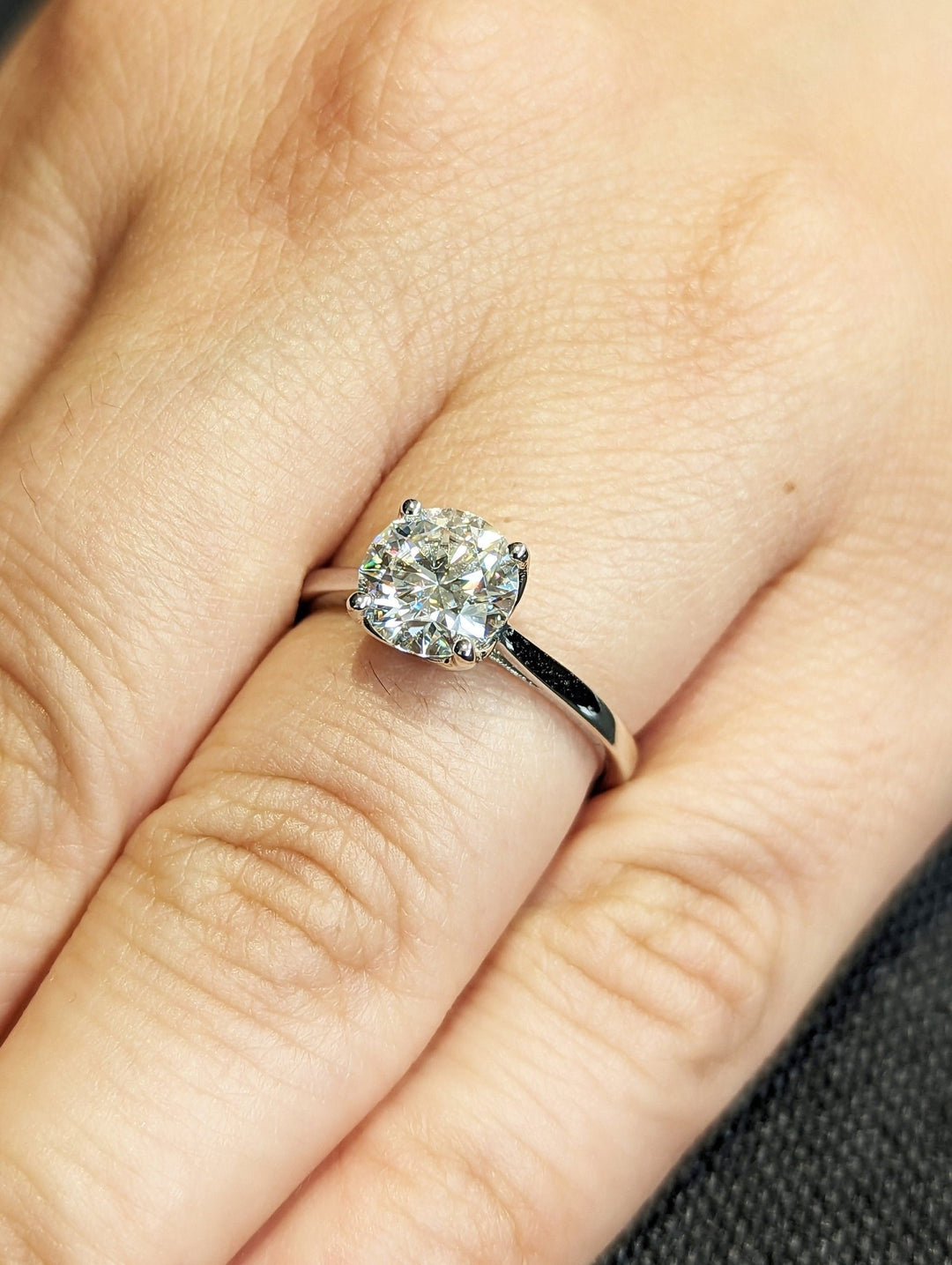 Profile view of round cut solitaire engagement ring band