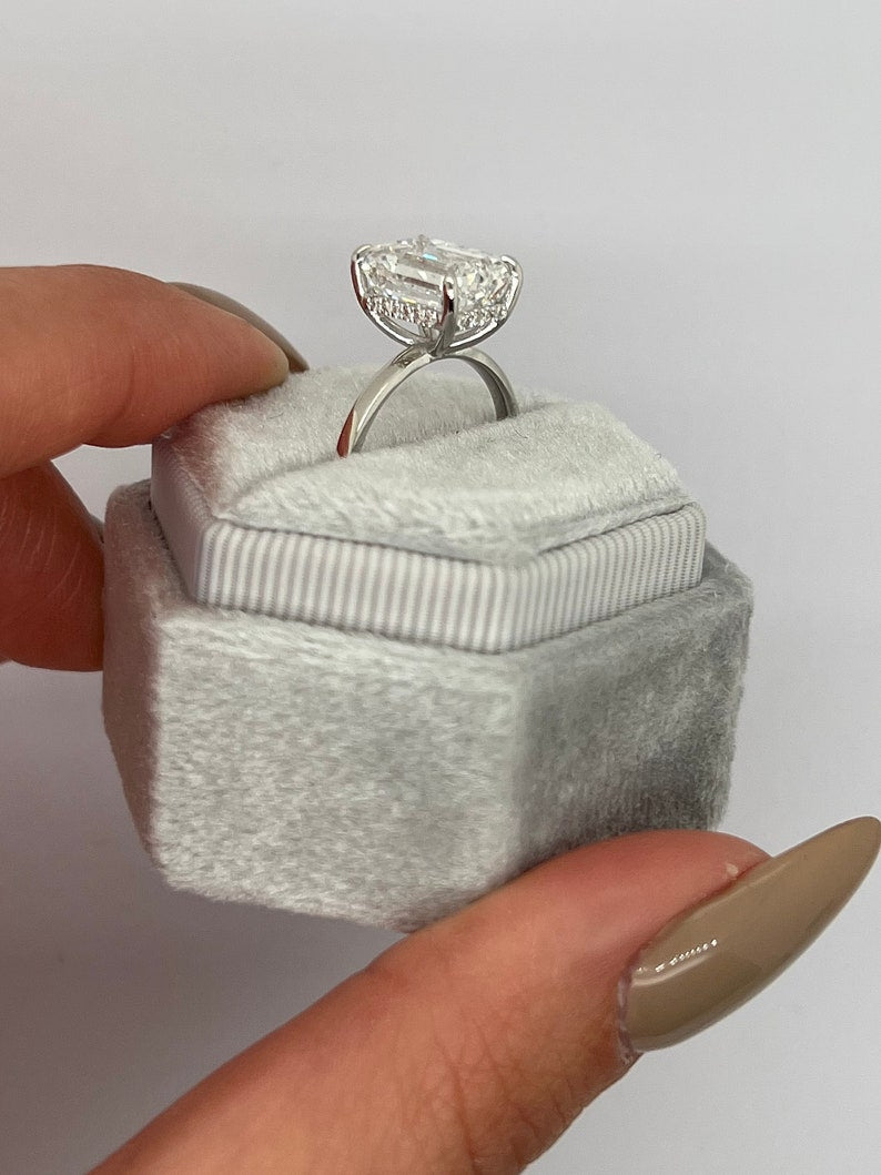 Profile view of emerald cut hidden halo engagement ring band