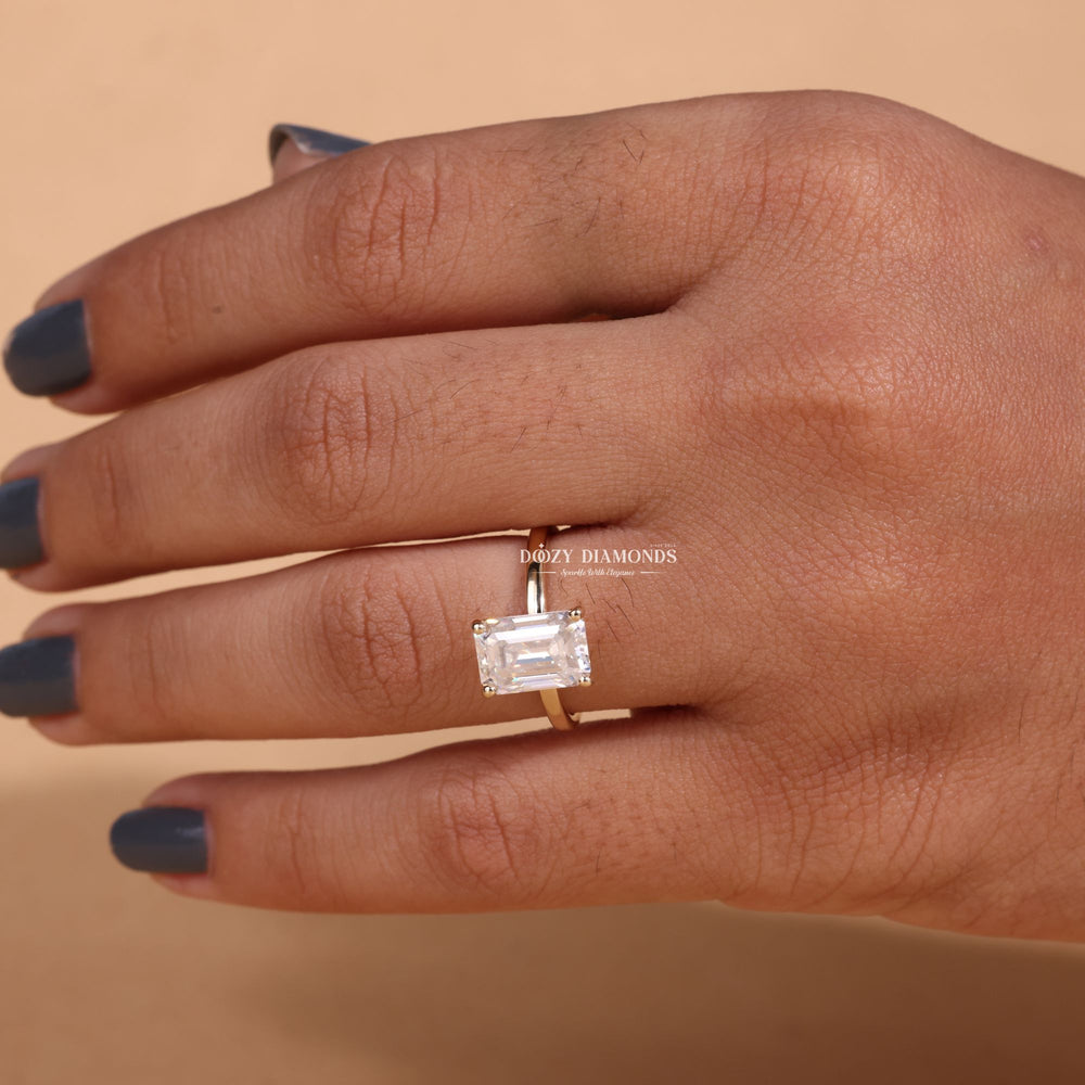 Emerald solitaire engagement ring close-up highlighting diamond sparkle