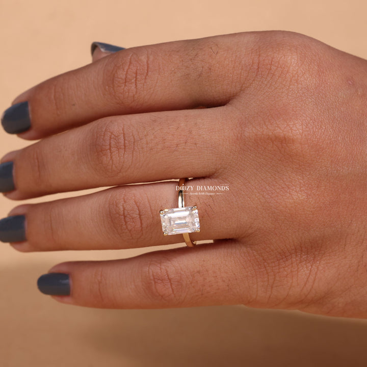 Emerald solitaire engagement ring close-up highlighting diamond sparkle