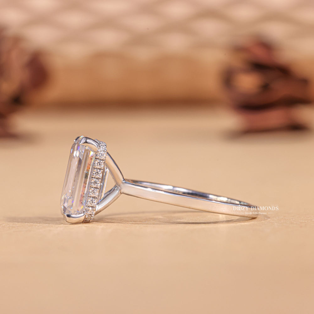 Profile view of emerald cut hidden halo engagement ring band