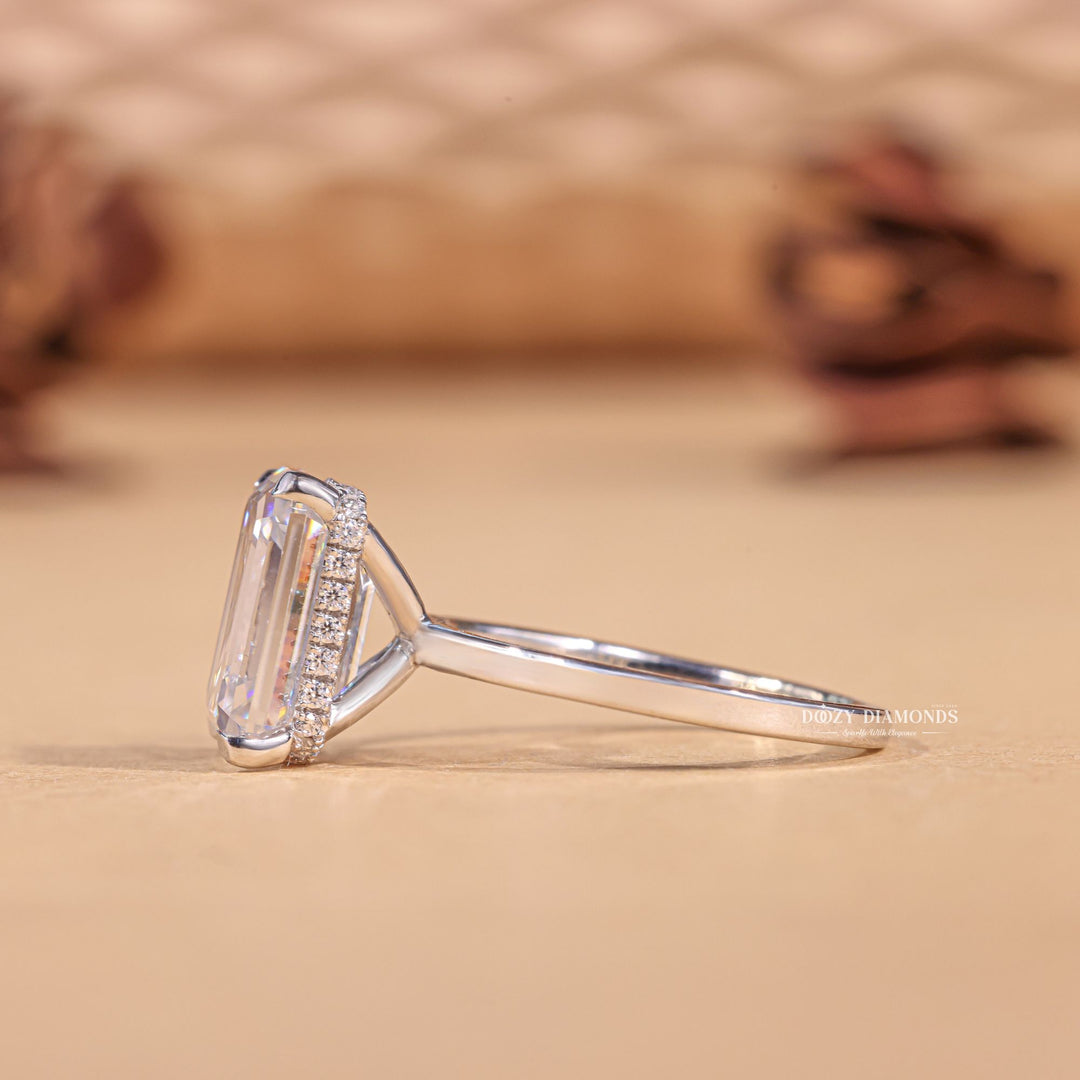 Profile view of emerald cut hidden halo engagement ring band