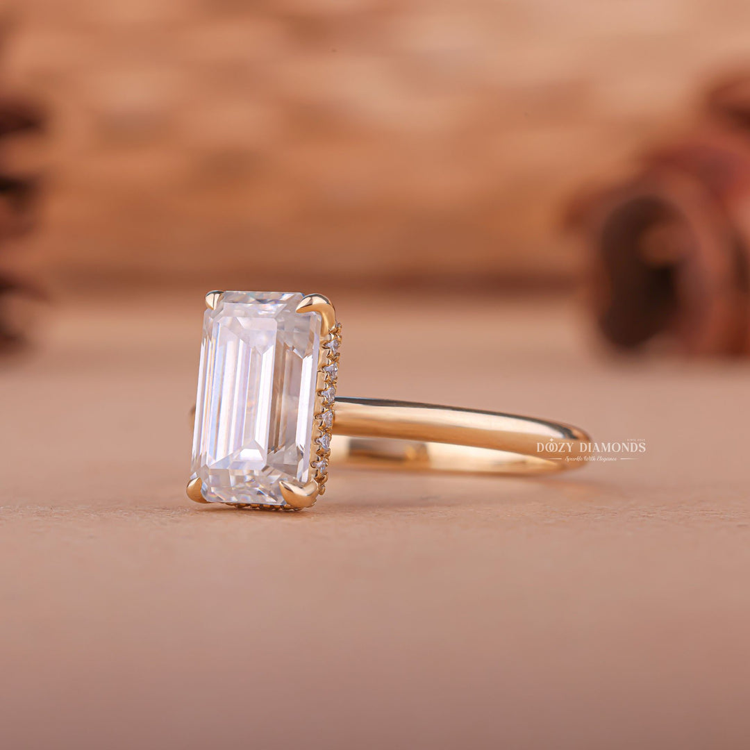 Profile view of emerald cut hidden halo engagement ring band