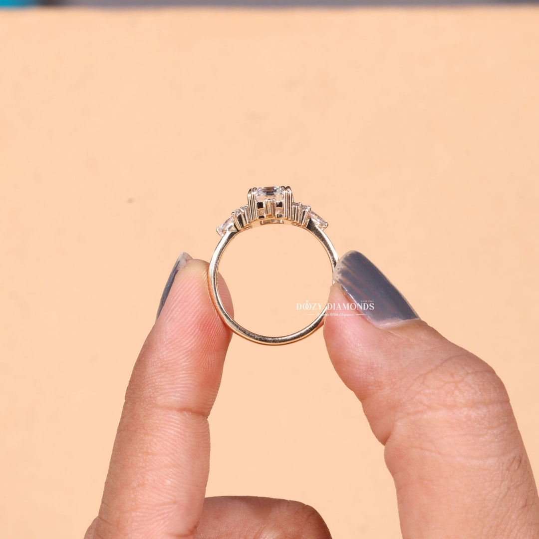 Emerald cluster diamond ring displayed on jewelry stand