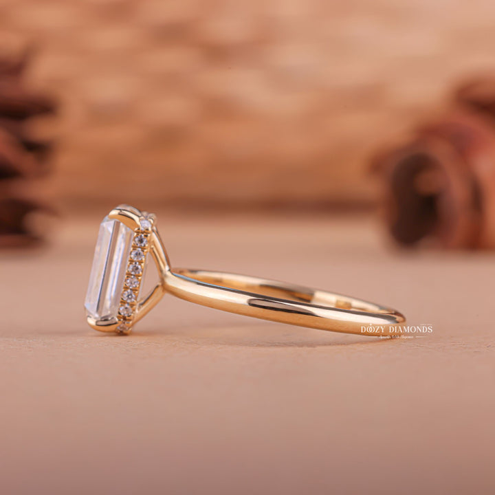 Emerald hidden halo engagement ring shown on hand for true-to-life sizing