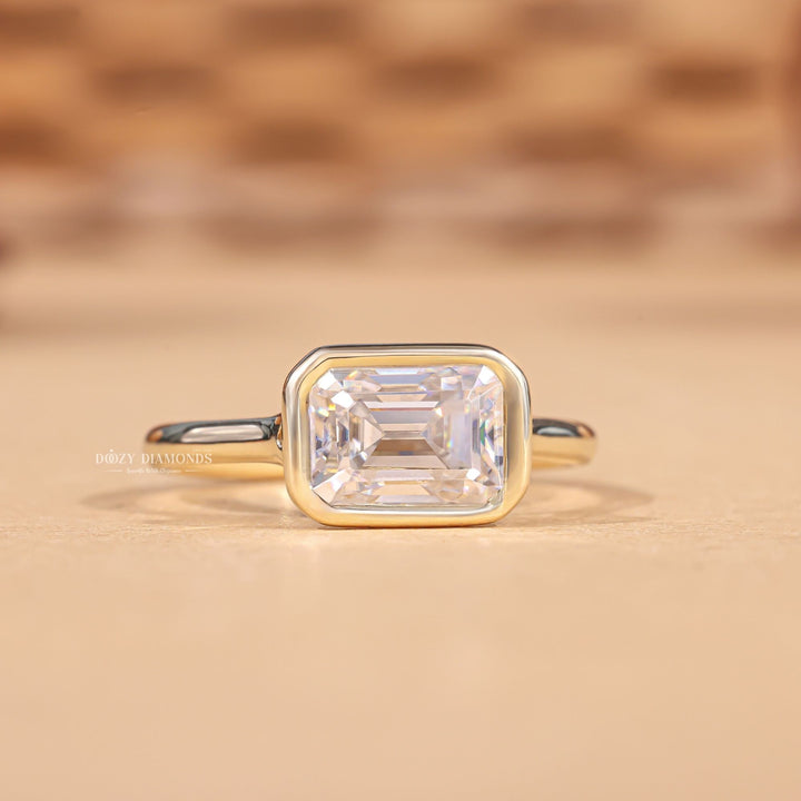 Emerald cut diamond ring worn on hand